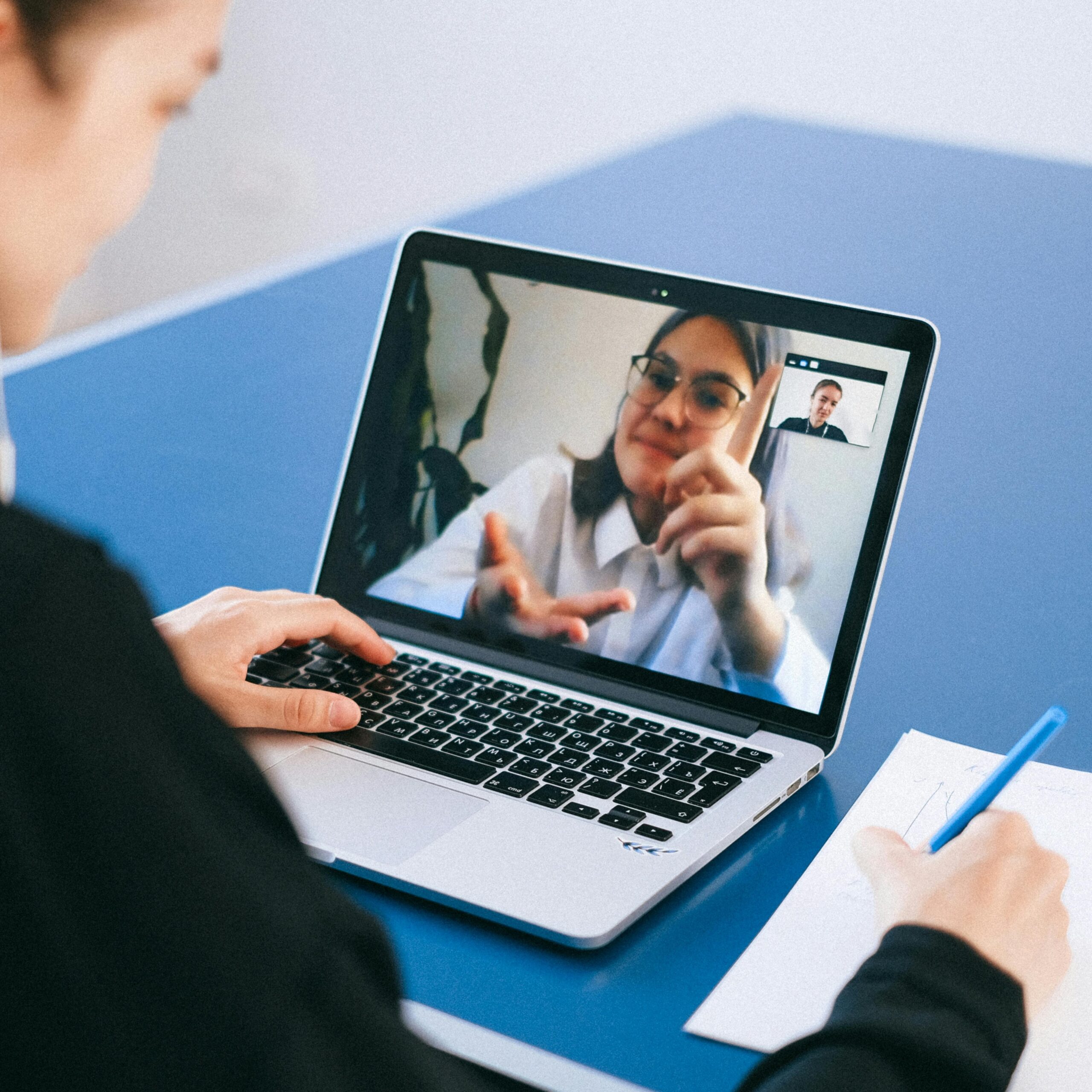 A virtual therapy session on a laptop, showcasing personalized care and connection between a therapist and a client.